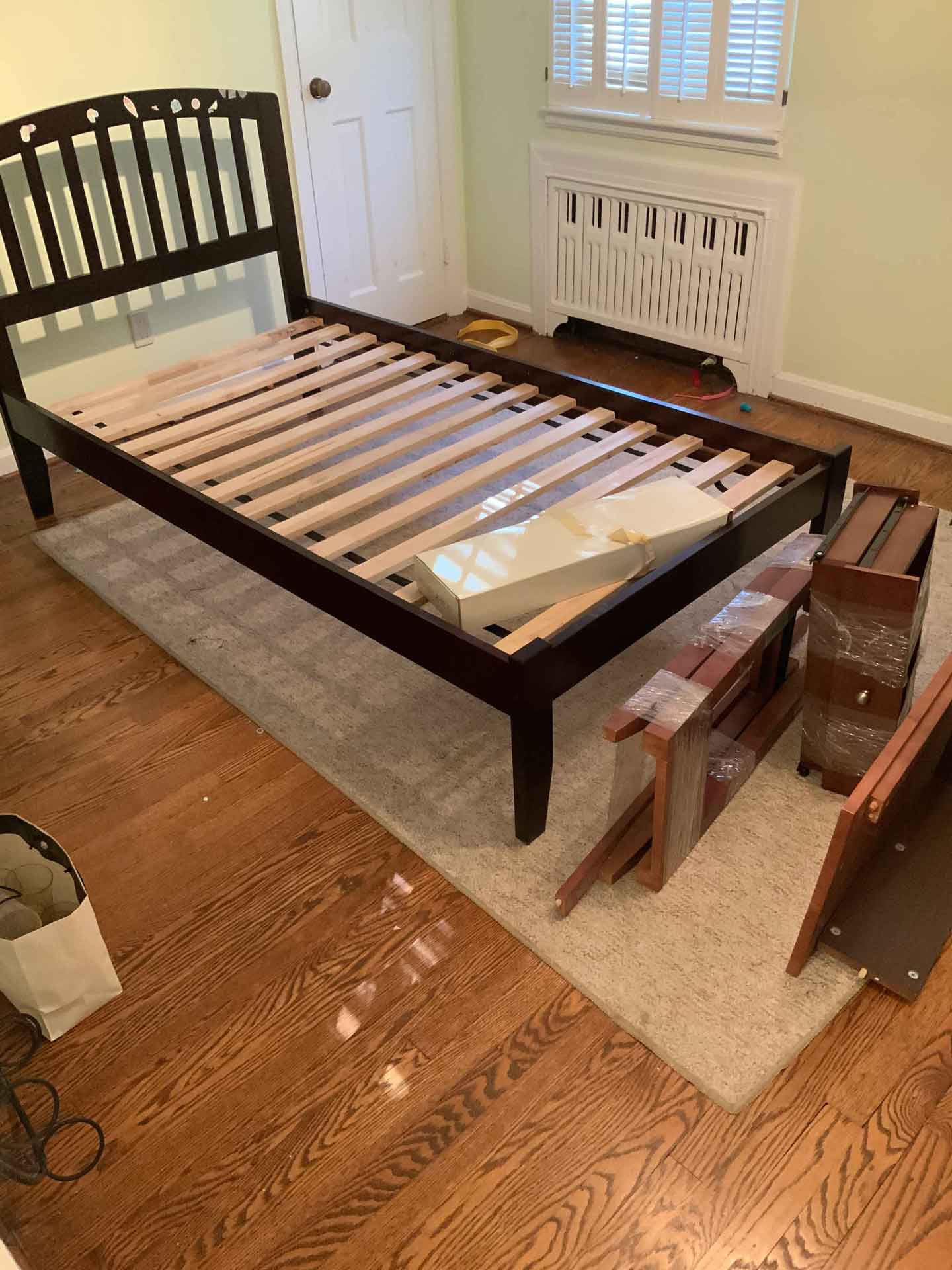 Wooden twin bed with parts of a dresser