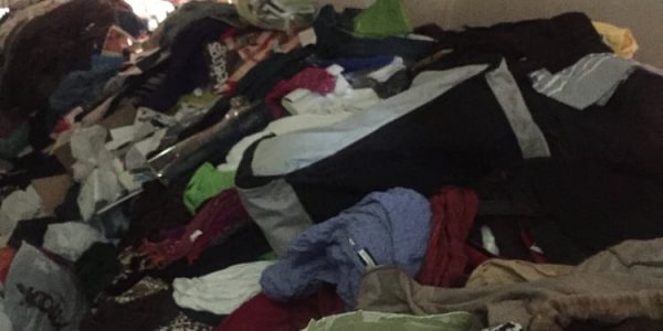 A cluttered room full of old clothes