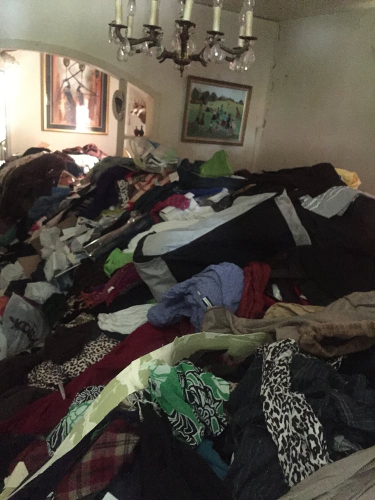 A cluttered room full of old clothes